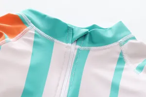 Macro detail of a kids swimwear zipper and striped collar with fine fabric texture