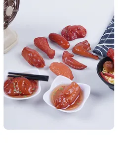 Detail of realistic miniature braised food toys including chicken wings and trotters