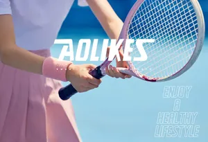 Action shot of a pink sweat-absorbent sports wristband worn during a tennis match