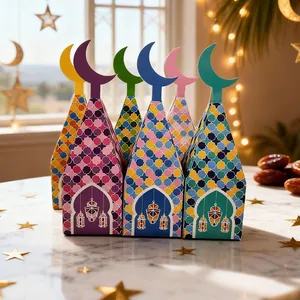 Detailed view of colorful Eid Mubarak candy gift boxes with crescent moon toppers and lanterns.