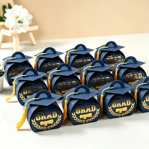 Elegant navy blue graduation cap candy boxes with gold foil "GRAD" text and yellow tassels.