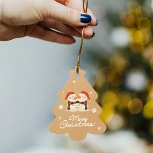 Set of 48 kraft paper Christmas tree shaped gift tags with cute snowman illustration