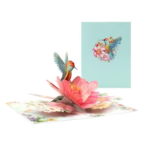 Detailed 3D pop-up greeting card featuring an artistic hummingbird and pink flowers