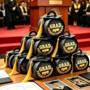 Close-up of black graduation cap gift boxes with gold foil GRAD and yellow tassels