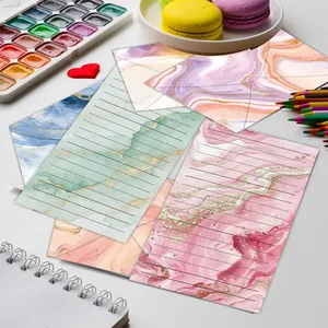 Detailed macro view of elegant marble watercolor letter paper and matching envelopes