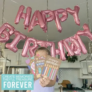 Young girl holding colorful cartoon birthday greeting cards with party decor background