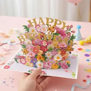 Detailed close-up of 3D pop-up flower bouquet greeting card with glittery text design