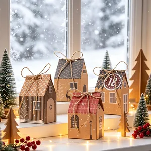 Scatole di caramelle festive in carta kraft a forma di casa in una finestra innevata.