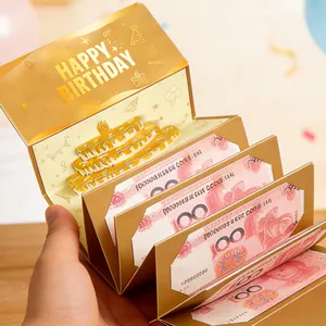 Vista detallada de tarjeta de cumpleaños 3D pop-up dorada con tarta y ranuras para dinero