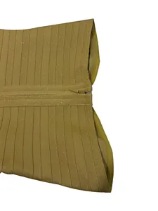 Detailed macro view of gold glitter ribbed bandage dress fabric with zipper