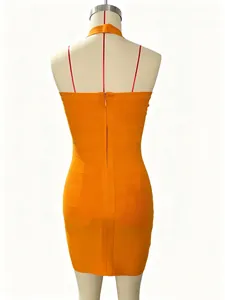 Close-up back view of a sexy orange bandage bodycon mini dress with halter neck strap