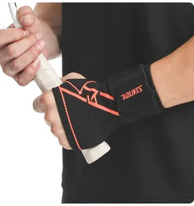 Close-up detail of black breathable compression wrist and palm support with orange accents.