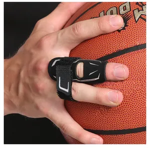 Close-up of black adjustable sports finger protector held against a basketball