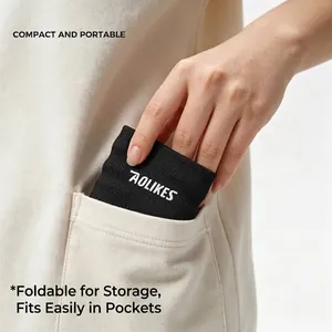 Black AOLIKES sports headband being tucked into a pocket showing compact and portable design