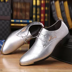 Detailed view of silver men's derby shoes featuring gold accents and crinkled leather texture