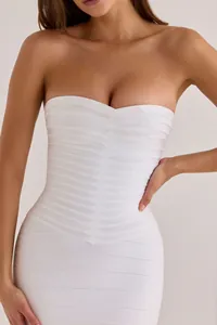 Detailed macro view of a white strapless bandage bodycon dress with V-stitch pattern