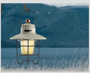 Vista dettagliata di una lanterna da campeggio a LED retrò appesa in un ambiente naturale