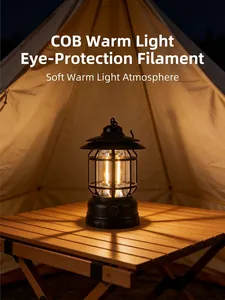 Close-up of a vintage black COB camping lantern glowing with warm light inside a cozy tent