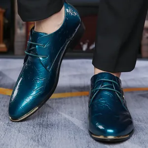 Detailed macro view of shiny teal Derby shoes with textured leather and gold toe accents