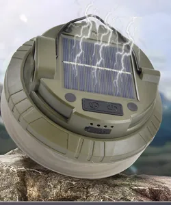 Macro detail of solar camping light with integrated panel and olive green rugged shell