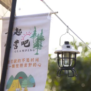 Portable vintage style white LED camping lantern hanging for outdoor glamping ambiance