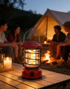Vintage style red camping lantern providing warm ambient light in an outdoor tent scene.