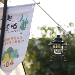 Vintage rechargeable LED camping lantern hanging outdoors for glamping atmosphere light