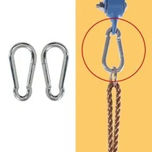 Detail view of two silver metal carabiners being used with a rope and hoist system.