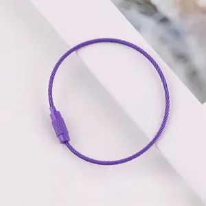 Close-up of a purple lacquered steel wire keychain loop with screw fastener