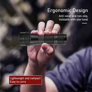 Compact high-power black tactical LED flashlight held in hand for outdoor camping