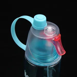 Detail view showing the functional spray nozzle and blue cap of a sports water bottle