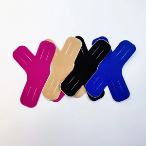 Close-up detail of X-shaped kinesiology tape in four colors for sports muscle support