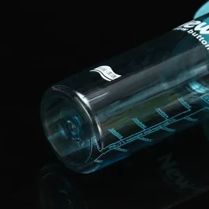 Detailed macro view of blue plastic sports spray bottle base with capacity scale