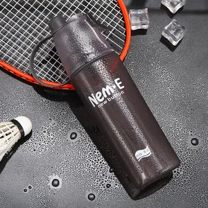 Close-up of sports spray water bottle with cooling ice and badminton racket props