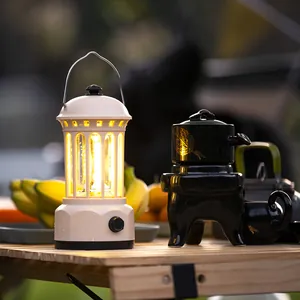 Vintage style outdoor portable camping lantern with warm LED COB lighting on wooden table