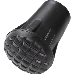 Detailed macro view of black rubber trekking pole tip cover with anti-slip grid