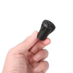 Macro view of durable black rubber trekking pole tip cover featuring non-slip texture