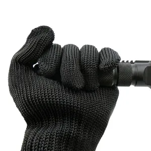 Detail view of Level 5 cut-resistant steel wire glove protecting hand from a sharp blade
