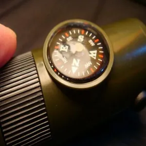 Close-up of the built-in compass on the 7-in-1 multi-functional survival whistle