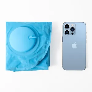 Portable blue inflatable pillow shown next to a smartphone for size comparison