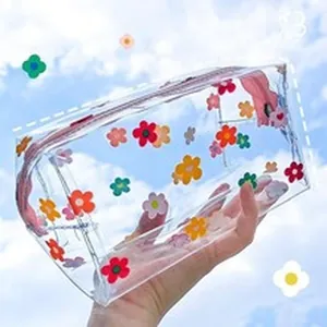 Detailed view of a transparent PVC pouch featuring colorful floral prints and pink zipper