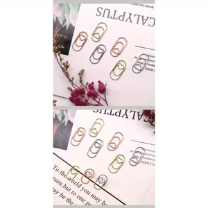 Dettaglio di graffette a forma di cuore mini in oro rosa e oro per cancelleria