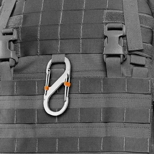 Detail view of silver 8-shaped carabiner with orange locks on tactical backpack