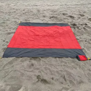 Waterproof sand-free 210T polyester beach mat in red and black patchwork colorway