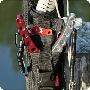 Macro detail view of black coiled fishing safety lanyard attached to a tool holster.