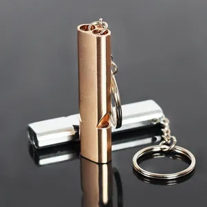 Macro view of gold and silver double tube aluminum alloy emergency survival whistles