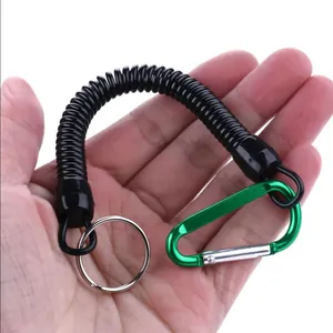 Detail of elastic coiled fishing lanyard with green carabiner and split ring.