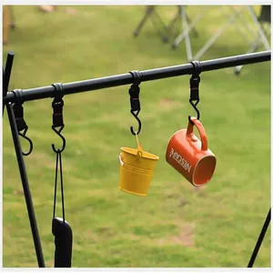 Close-up detail of outdoor camping rack hooks holding a yellow bucket and orange mug