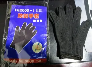 Close-up view of reinforced cut-resistant black gloves with original retail packaging.