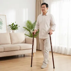 Elderly man using two premium solid wood walking canes in a bright living room setting.